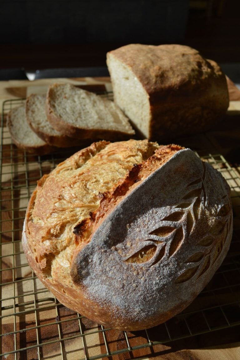 Two loaves of sourdough bread on cooling rack