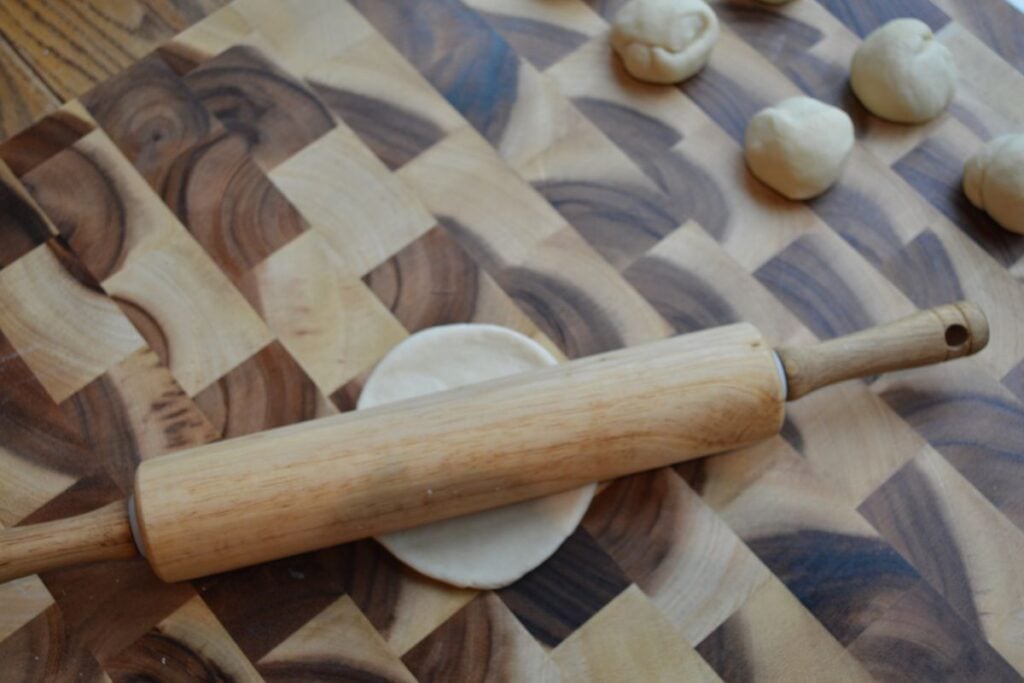 Rolling pin rolling sourdough tortilla
