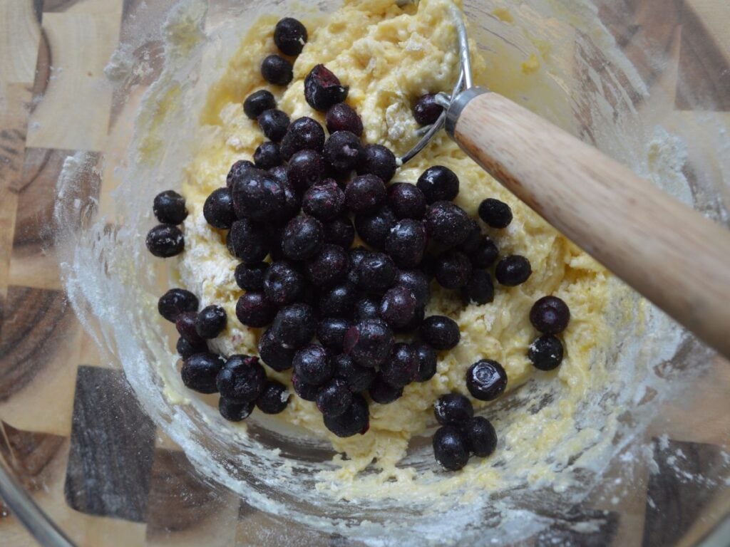 Blueberries added ontop of muffin batter
