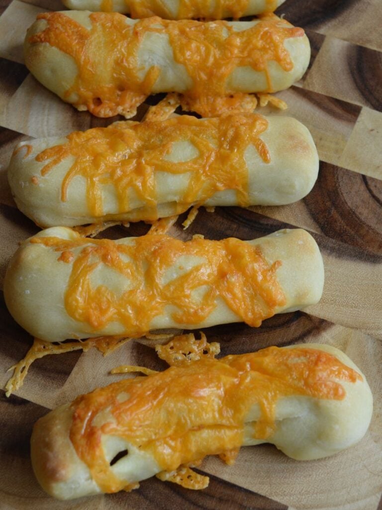 Pepperoni cheese sticks on cutting board
