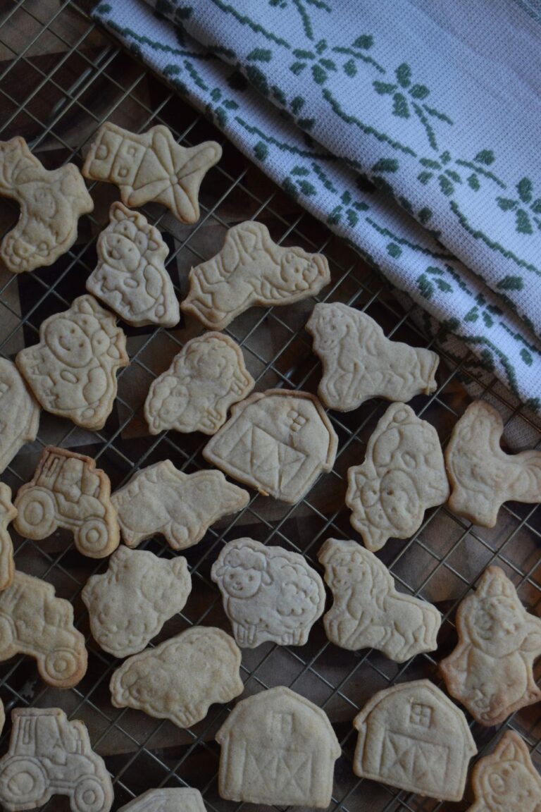 Sourdough Animal Crackers on cooling rack with tea towel in corner