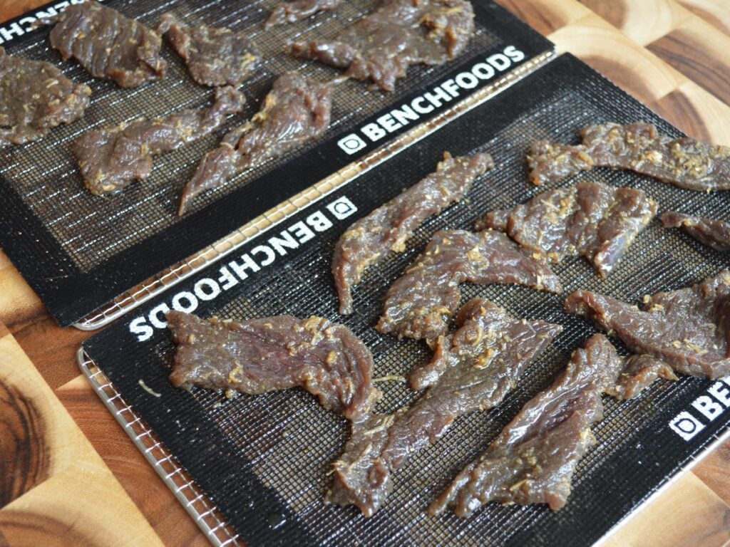 Venison Jerky laid out on dehydrator trays