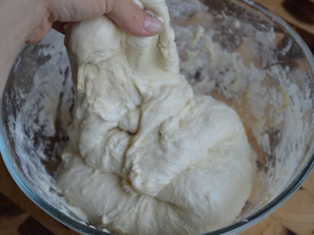 Hand stretch and folding sourdough bagel dough
